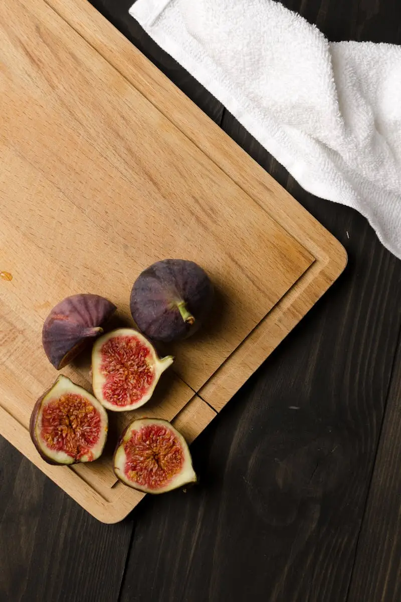 Vertical shot of fresh figs on a wooden cutting board, perfect for healthy eating concepts.
